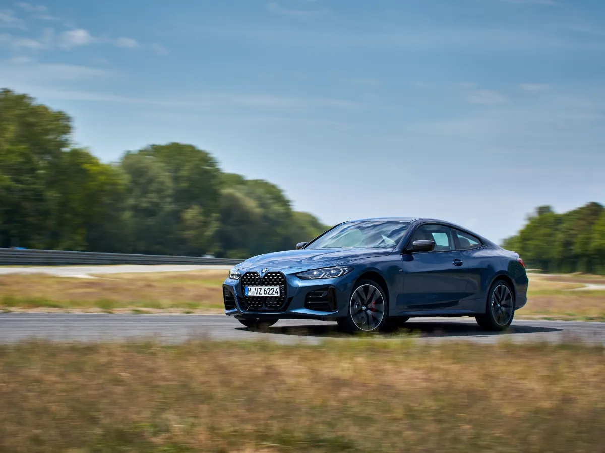 BMW 4 Series Coupé in blue, in a field